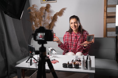 Young woman make up artist, professional beauty vlogger or blogger recording makeup tutorial for website or social media. Business online influencer on social media concept.の写真素材
