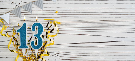 Number 13 blue celebration candle on white wooden background. happy birthday candles. Concept of celebrating birthday, anniversary, important date, holiday. copyspace. Bannerの写真素材