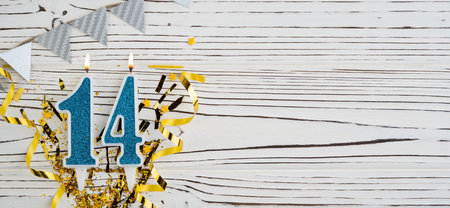 Number 14 blue celebration candle on white wooden background. happy birthday candles. Concept of celebrating birthday, anniversary, important date, holiday. copyspace. Bannerの写真素材