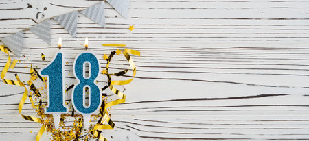 Number 18 blue celebration candle on white wooden background. happy birthday candles. Concept of celebrating birthday, anniversary, important date, holiday. copyspace. Bannerの写真素材