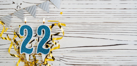 Number 22 blue celebration candle on white wooden background. happy birthday candles. Concept of celebrating birthday, anniversary, important date, holiday. copyspace. Bannerの写真素材