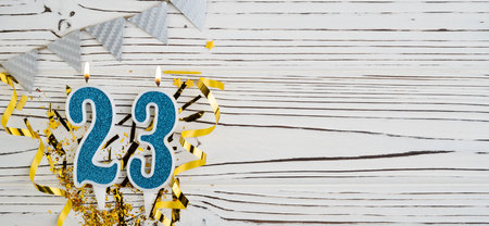Number 23 blue celebration candle on white wooden background. happy birthday candles. Concept of celebrating birthday, anniversary, important date, holiday. copyspace. Bannerの写真素材