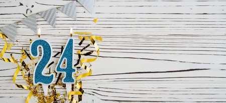 Number 24 blue celebration candle on white wooden background. happy birthday candles. Concept of celebrating birthday, anniversary, important date, holiday. copyspace. Bannerの写真素材