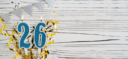 Number 26 blue celebration candle on white wooden background. happy birthday candles. Concept of celebrating birthday, anniversary, important date, holiday. copyspace. Bannerの写真素材