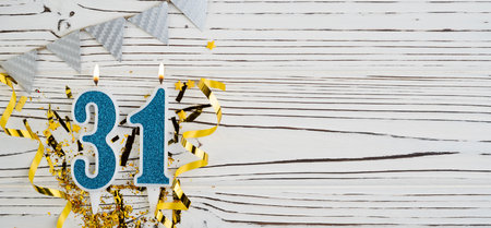 Number 31 blue celebration candle on white wooden background. happy birthday candles. Concept of celebrating birthday, anniversary, important date, holiday. copyspace. Bannerの写真素材