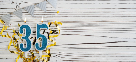 Number 35 blue celebration candle on white wooden background. happy birthday candles. Concept of celebrating birthday, anniversary, important date, holiday. copyspace. Bannerの写真素材