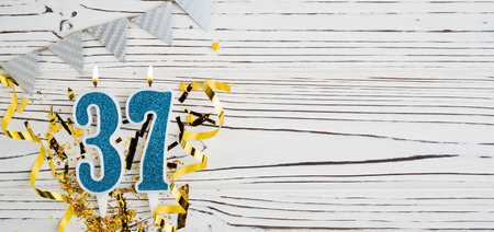 Number 37 blue celebration candle on white wooden background. happy birthday candles. Concept of celebrating birthday, anniversary, important date, holiday. copyspace. Bannerの写真素材