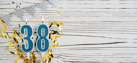 Number 38 blue celebration candle on white wooden background. happy birthday candles. Concept of celebrating birthday, anniversary, important date, holiday. copyspace. Bannerの写真素材