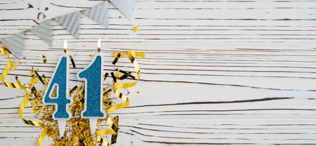 Number 41 blue celebration candle on white wooden background. happy birthday candles. Concept of celebrating birthday, anniversary, important date, holiday. copyspace. Bannerの写真素材
