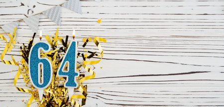 Number 64 blue celebration candle on white wooden background. Happy birthday candles. Concept of celebrating birthday, anniversary, important date, holiday. Copy space.の写真素材