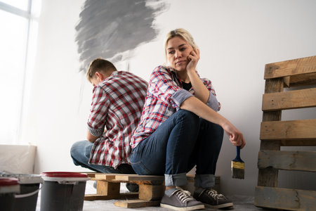 Offended couple has conflict planning painting walls and interior in new houseの写真素材