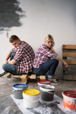 Misunderstanding between partners in relationship. Breakup between spouses. Girlfriend and boyfriend arguing, repairing their new home.の写真素材