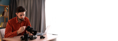 Creative process or workflow of freelance male photographer or director. Export or transfer data files, images and videos from camera to laptop at home officeの写真素材