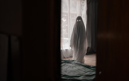 Scary white ghost made from a sheet in an abandoned house. Halloween conceptの写真素材