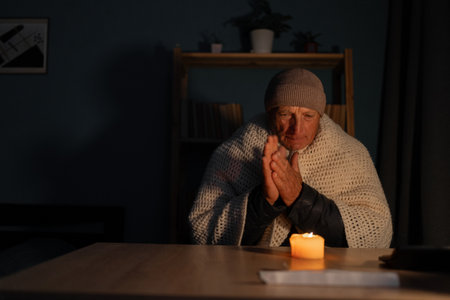 Old man suffers in no heating and no electricity during an energy crisis causing blackouts. No heatingの写真素材