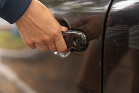 Close-up of a female hand opening a car doorの写真素材