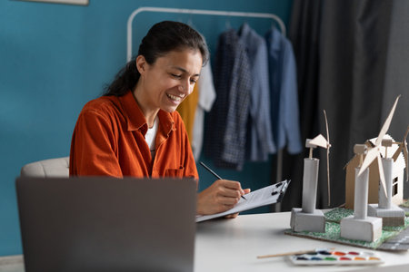 Young female engineer developing project of wind turbines in her home office