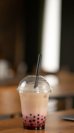 Thai milk tea with bubbles in cafe restaurant on the table over interior backgroundの写真素材