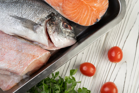 Sea delicacies on white background. Fresh seafood in restaurant. Fish perch and salmonの写真素材