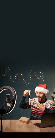 Arabic guy pointing out at favorite smart watch while recording video on mobile phone camera. Creative vlogger telling subscribers about best present for women.の写真素材