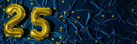 number twenty five, gold foil balloon number on blue velvet background with confetti. Birthday...