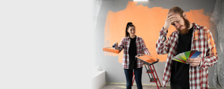 Conflict, repair and renovation concept. Young couple with bad emotions and stress during renovation in apartment or in new houseの写真素材