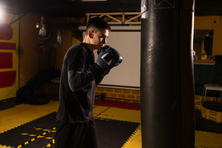 Young boxer workout a kick on punching bag in gym. Sport and active lifestyle conceptの写真素材