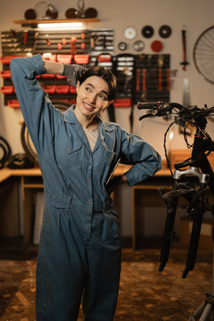 Portrait of sad terrified lady horrified facial expression made big mistake standing in bike repair shop or workshop.の写真素材