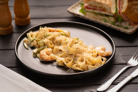 Pasta with Shrimp and Cream Sauce on black plate, Mediterranean Food. Italian Cuisine conceptの写真素材