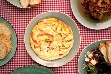 Omelette with red bell pepper on table. Healthy diet food for breakfast.の写真素材