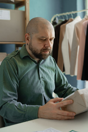 Delivery service worker and working packing box, business owner working checking order before...