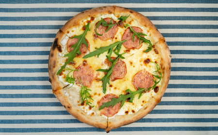 Pizza with sausage, cheese and arugula. Spring menu. Pizzeria conceptの写真素材