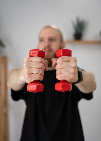 Fit Athletic Young Man Training Lifting Dumbbells Workout at Home