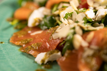 Salad with salted salmon, avocado, feta cheese and pine nuts, close-upの写真素材
