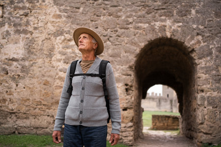 Senior traveler exploring ancient fortress during sightseeing tourの写真素材