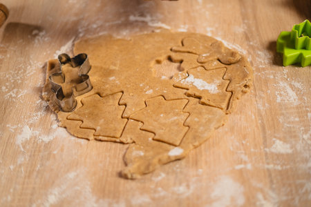 Gingerbread cookie dough cut into gingerbread men and tree.の写真素材