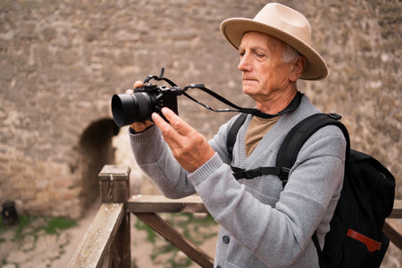 Retired tourist and photographer exploring European cities, taking photos of ancient fortress, documenting landmarks while traveling.の写真素材