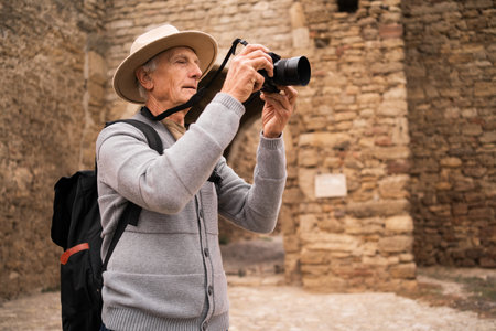 Retired man, passionate photographer and tourist, exploring European cities and documenting ancient fortress, capturing historical landmarks along the way.の写真素材