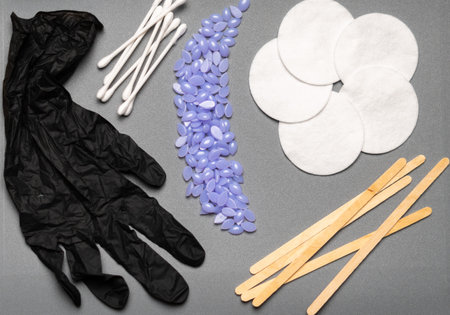 Set for epilation or depilation on gray background, flat lay.