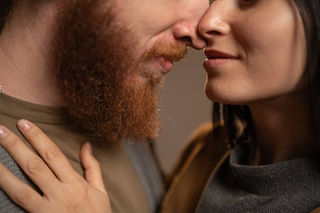 Lovely moment and passionate affection. Couple in love kissing, close-up. Young man and woman kiss for romanceの写真素材