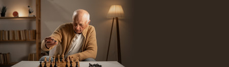 Retired man focused on a chess game thinking deeply about his next move in a cozy living room. An elderly gentleman immersed in strategy enjoying a quiet evening at homeの写真素材