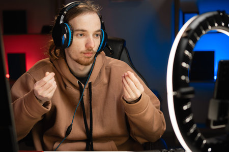 Vlogger gamer broadcasts live streaming to review video game on social media, showing money salary...
