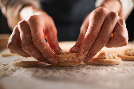 Close-Up of Hands Preparing Dumplings with Cottage Cheeseの写真素材