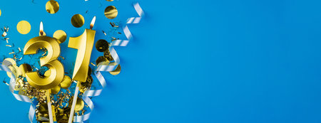 Celebrating 31 years. Golden burning candle in form of number thirty one on celebration festive blue background lying in sparkles. Holiday banner with copy space.の写真素材