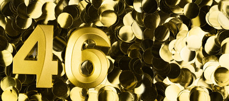 Golden number forty-six candle on shiny yellow confetti background. Festive backdrop for forty-sixth birthday, anniversary or celebration. Bright greeting card with space for text.の写真素材