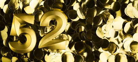 Golden number fifty-two 52 candle on shiny yellow confetti background. Festive backdrop for fifty-second birthday, anniversary, or celebration. Bright greeting card with space for text.の写真素材