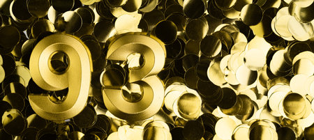 Golden number ninety-three 93 candle on shiny yellow confetti background. Festive backdrop for ninety-third birthday, anniversary, or celebration. Bright greeting card with space for text.の写真素材