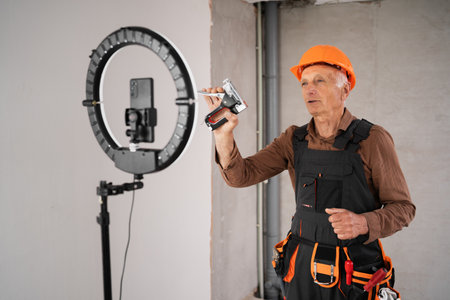 Male builder blogger is broadcasting live on social networks.の写真素材
