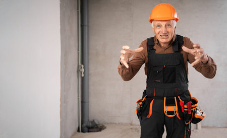 Building problems and troubles. Mad elderly construction worker gesturing In anger