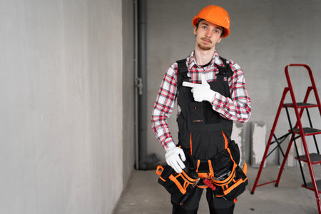 builder at construction site gesturing on the space for advertising